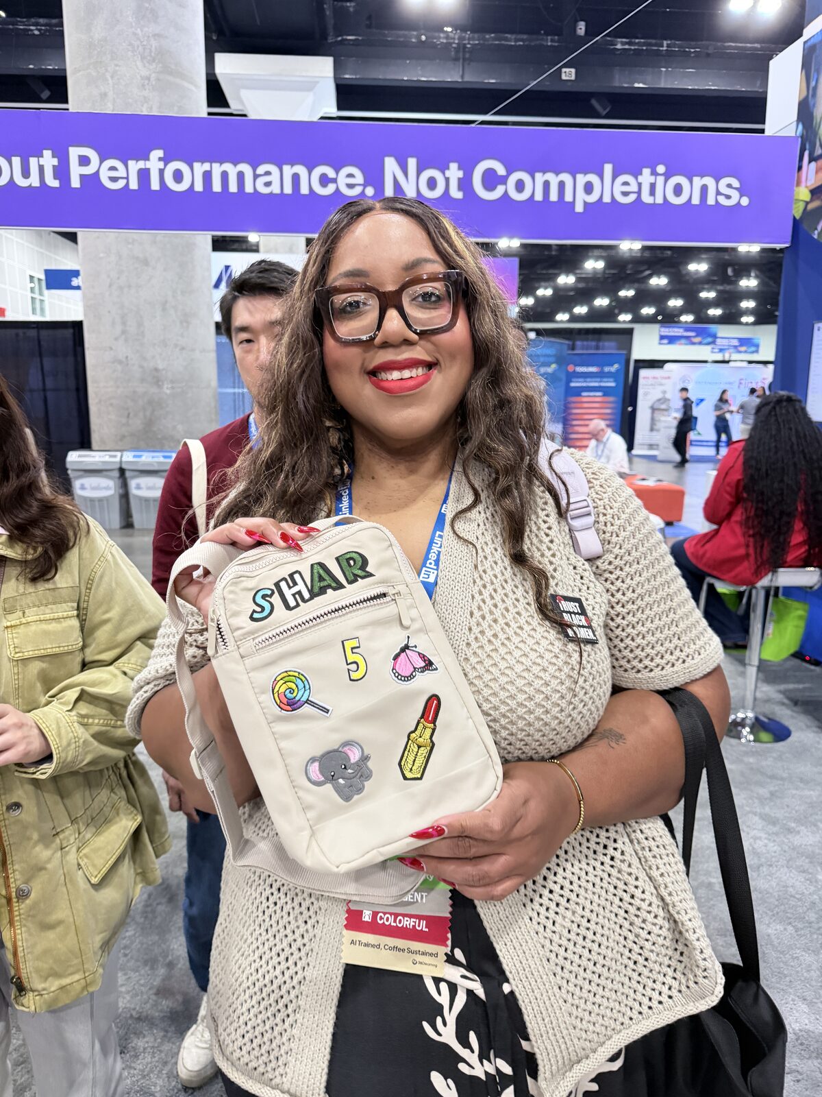 A smiling wedding guest holding a favor bag made at the live station